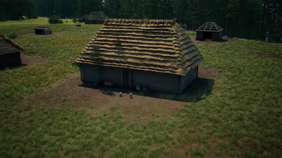 A larger log house with a deep hipped straw roof on a broad dirt yard, other buildings beyond.
