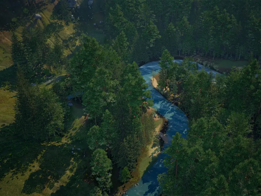 A blue river winding through dark pine forest, with sunlit meadow and scattered boulders on the slope beside it, seen from above.
