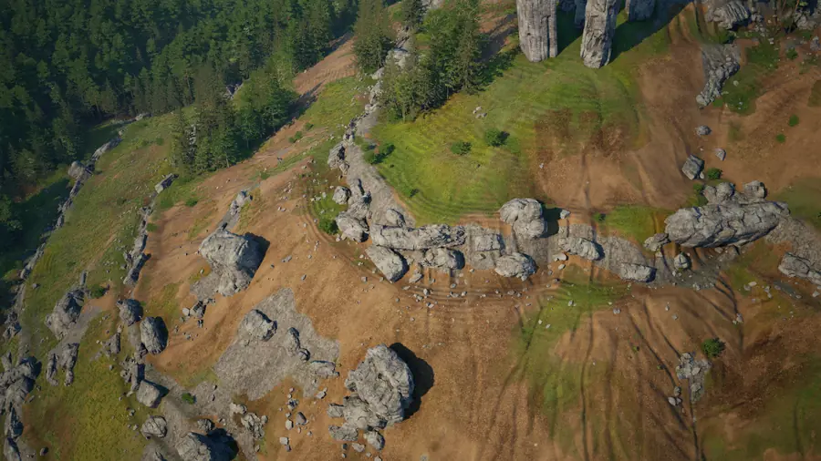 A steep hillside of bare earth with a band of grey boulders and outcrops, grass and young trees growing between them.